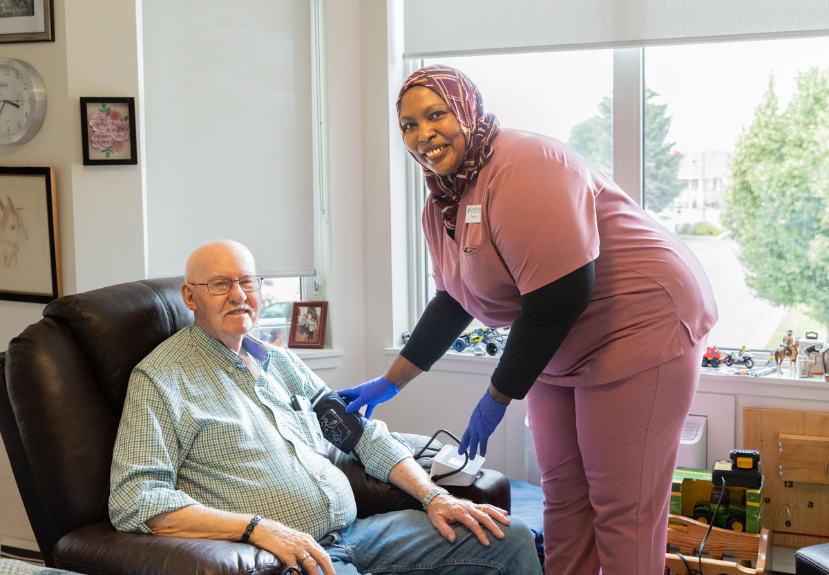 team member taking residents blood pressure